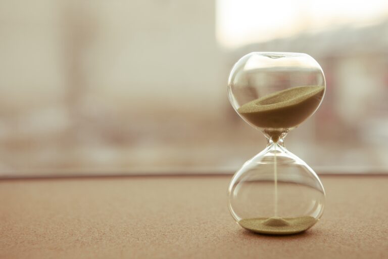 Sand running through the bulbs of an hourglass measuring the passing time